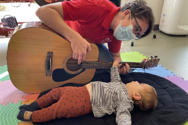 Playing music to a baby at Noah's Ark Children's Hopsice